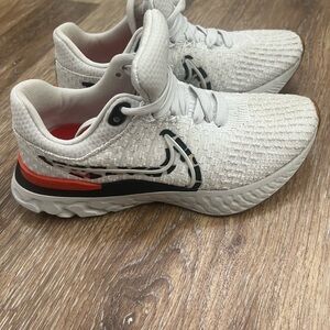 Nike Kids White Sneakers with Orange and Black Accents